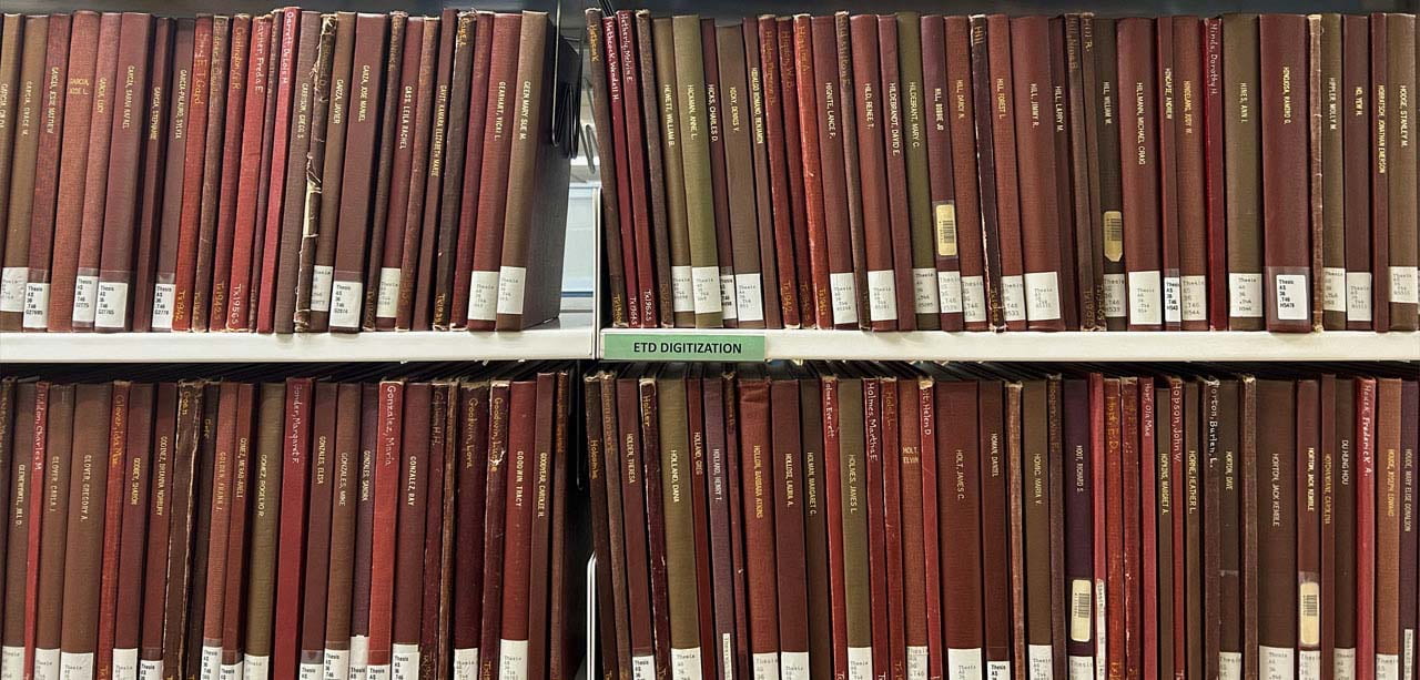 Book shelves showing bound theses & dissertations.